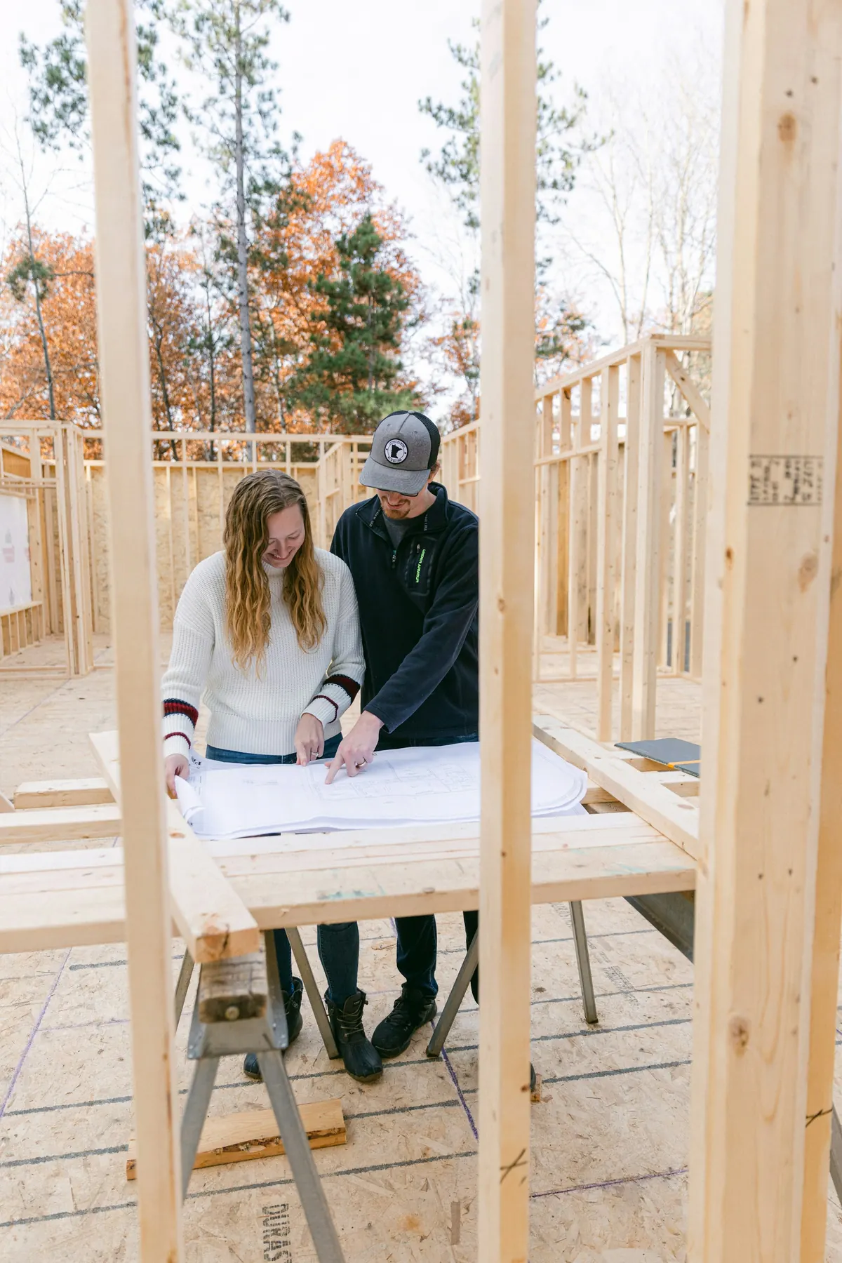 Couple reviewing plans inside a newly framed room