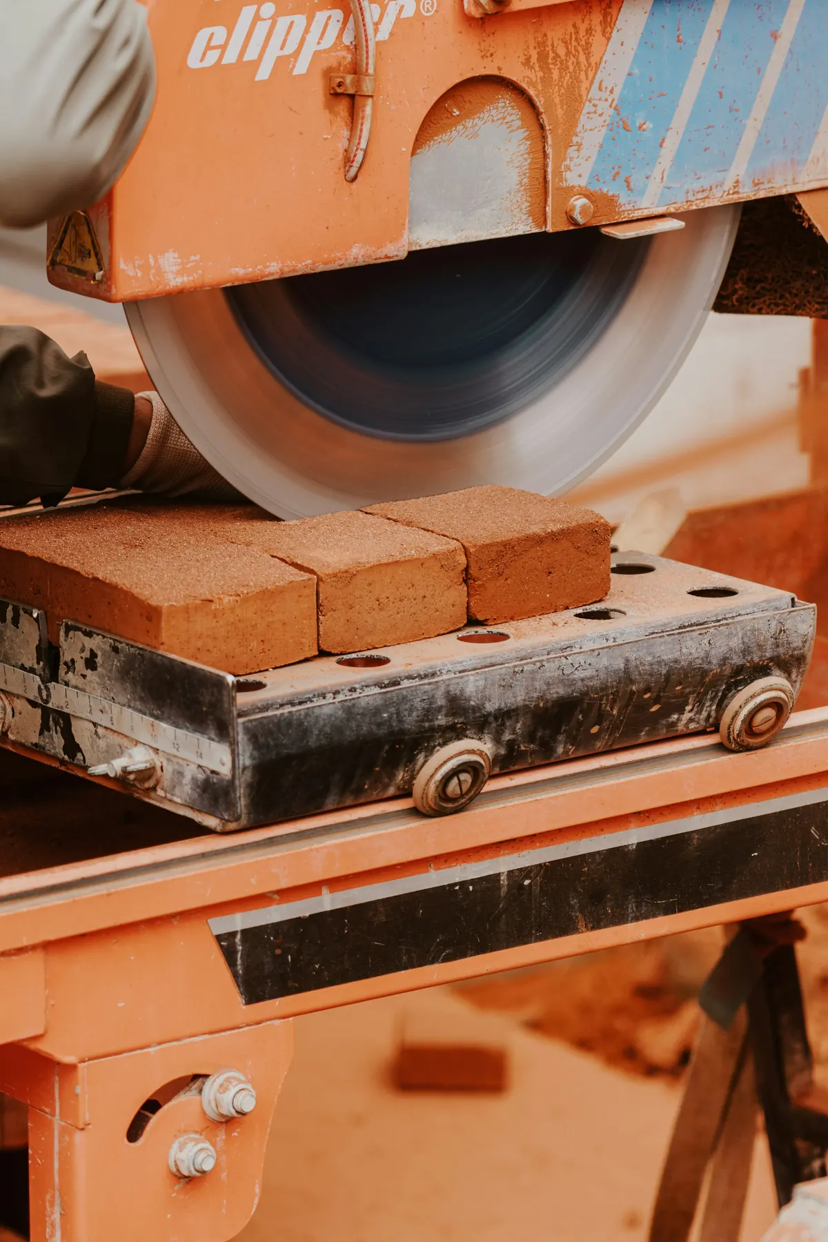 Worker cutting brick on a wet masonry saw